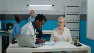 Older woman consulting a doctor about Medicare Plan N vs Plan F benefits