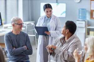 Doctor explaining Medicare coverage to senior patients in a healthcare setting