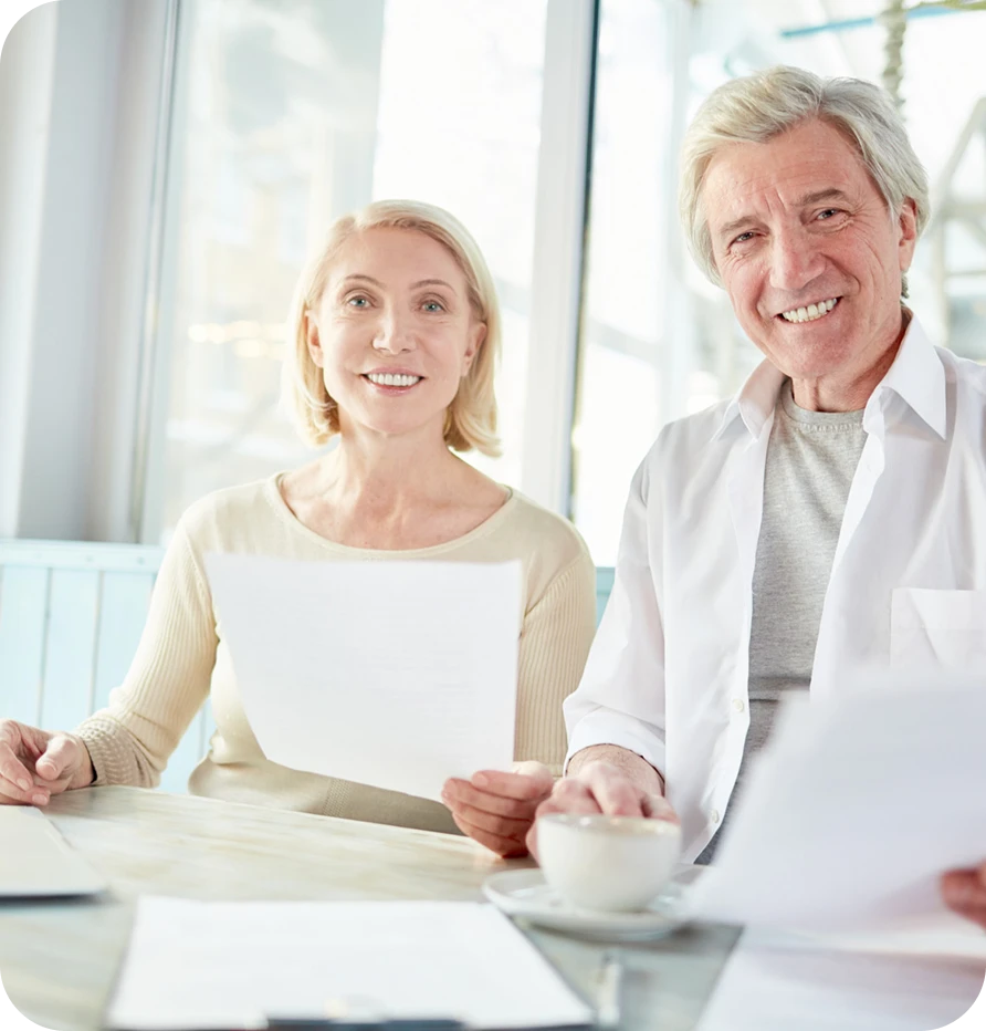 two adults working with paper documents
