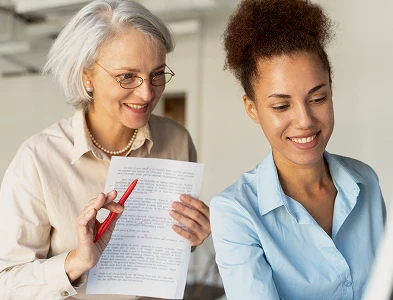 two adults working with paper documents