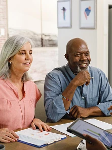 two adults working with paper documents