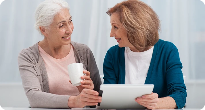 two adults working with paper documents