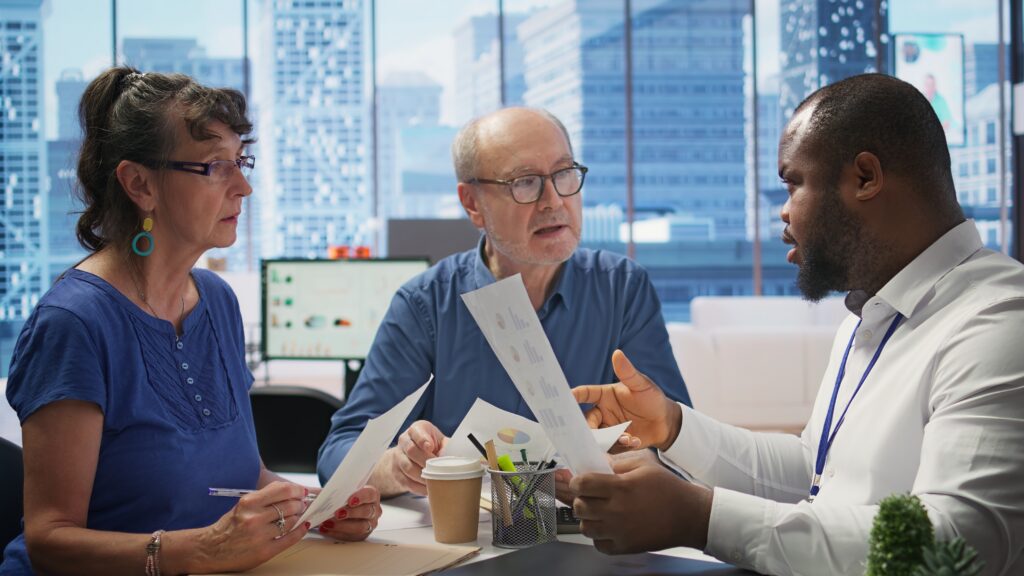 Senior couple reviewing Medicare paperwork with an advisor